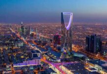 US Hub Blitzed — Casualties Kept Murky Kingdom Centre Tower illuminated over a sprawling city at dusk