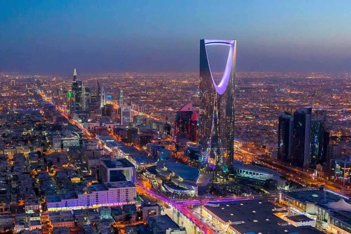 shutterstock_1224851173 Kingdom Centre Tower illuminated over a sprawling city at dusk
