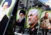 Iran Proxies Cornered—What Breaks First? Demonstrators holding large portraits of military and political figures during a protest