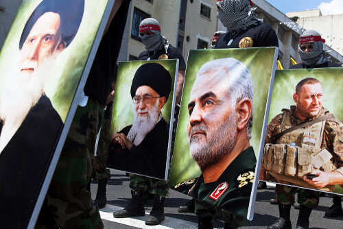 Quds,Day,Rally,,Parade,Of,Military,Forces,,Along,With,Photographs Demonstrators holding large portraits of military and political figures during a protest
