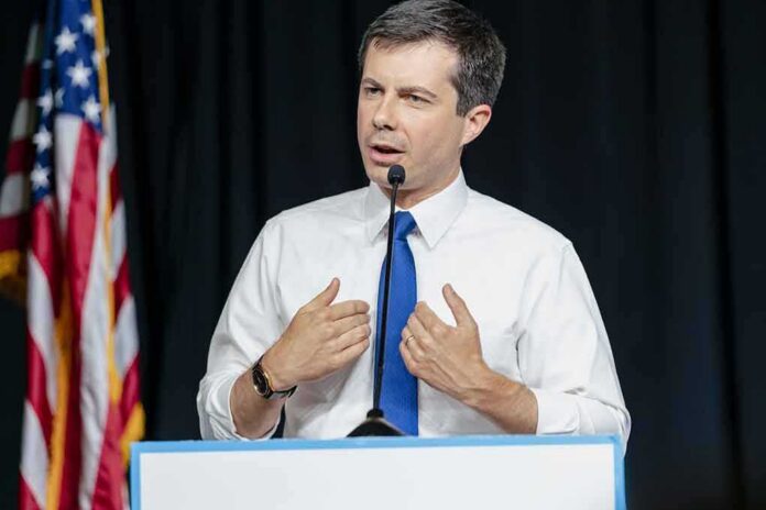 shutterstock_1426396838 man in white shirt and blue tie speaking at a podium