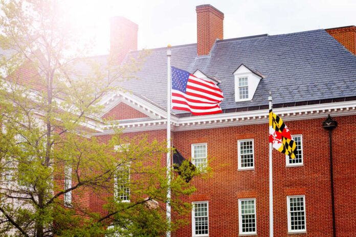 Us,Flag,In,Front,Of,Government,Building,In,Annapolis,,Maryland, Sign for U.S. Immigration and Customs Enforcement building.