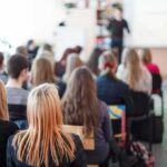 Student Brag Triggers Federal Crime Alarm Students seated in a classroom listening to a presentation