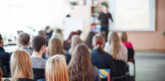 Students seated in a classroom listening to a presentation