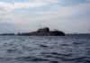 Pentagon Ignores Cheaper Boats—Why? A submarine in the ocean with people on its surface