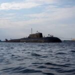 Pentagon Ignores Cheaper Boats—Why? A submarine in the ocean with people on its surface