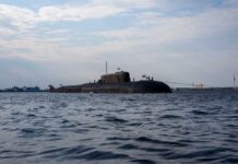 Pentagon Ignores Cheaper Boats—Why? A submarine in the ocean with people on its surface