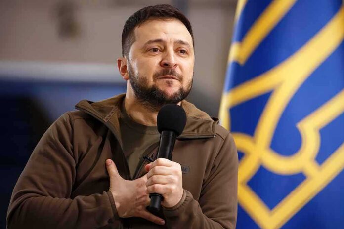 man holding a microphone with hand on chest