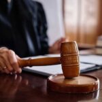 Mistress Flip Torches Husband’s Murder Cover-Up A judge's hand holding a gavel in a courtroom setting