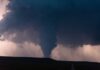Warning System Failed — Chaos on Geneva Lake A tornado forming under dark storm clouds with lightning in the background
