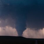 Warning System Failed — Chaos on Geneva Lake A tornado forming under dark storm clouds with lightning in the background