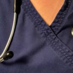 Nurse TikToks Ignite Healthcare Firestorm Stethoscope, pills, and Delayed Diagnosis booklet on table.