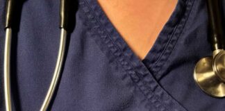 Stethoscope, pills, and Delayed Diagnosis booklet on table.