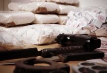 Banana Box Bust Stuns Italian Port Piles of bagged powder with a handgun on a table