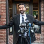 ‘Monsters’ Remark Ignites AIPAC Backlash Man in a suit speaking at outdoor press conference with multiple microphones