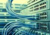 Massive Data Centers, Vanishing Wells Network switches with blue Ethernet cables