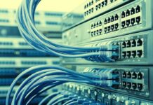 Massive Data Centers, Vanishing Wells Network switches with blue Ethernet cables