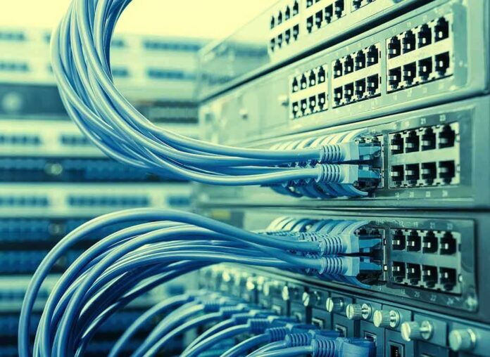shutterstock_341537273 Network switches with blue Ethernet cables