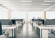 Did AI Target New Moms At Meta? Open-plan office with rows of desks and monitors