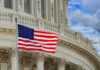Worldwide Warning: Americans on Edge American flag waving before neoclassical government building