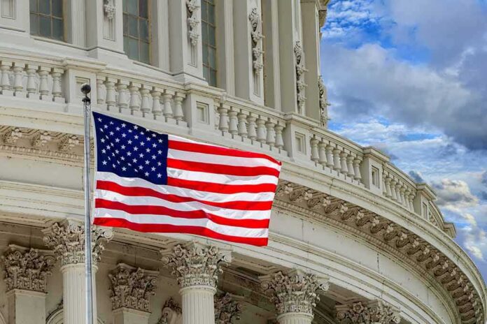 shutterstock_370611668 American flag waving before neoclassical government building