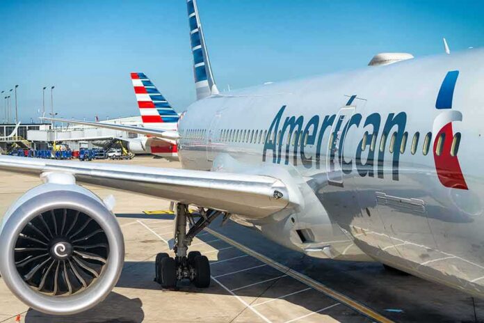 shutterstock_738219229 Commercial airplane at airport gate with engine and fuselage visible