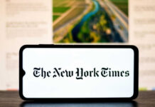 NYT Hit With Bias Charge—Then Strikes Back Smartphone displaying The New York Times logo