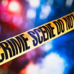 Jealous Rage: Motorcycle Mowed Down yellow crime scene tape with blurred police lights