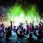 Pool Party Chaos After Chainsmokers Set Crowd dancing in a pool under colorful lights