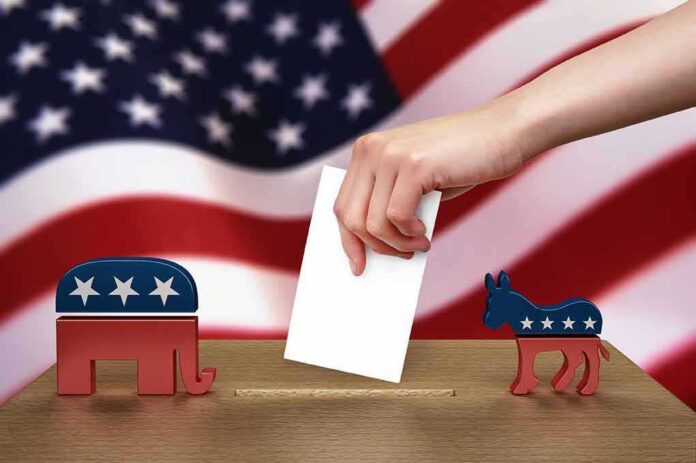 shutterstock_102884888 Hand casting ballot between Republican elephant and Democratic donkey
