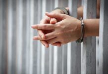 Medicaid Scam EXPOSED—Billed From Prison hands in handcuffs behind jail bars