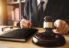Judge with gavel striking sound block