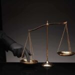 Judge FREEZES Trump TPS Kill Switch Golden balance scale with gloved hand pressing one pan