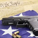 Congress Power Play: Local Bans Neutered? Handgun on American flag with ammunition and U.S. Constitution background