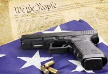 Congress Power Play: Local Bans Neutered? Handgun on American flag with ammunition and U.S. Constitution background