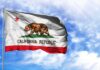 California state flag waving against a blue sky
