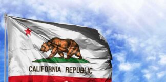 California state flag waving against a blue sky