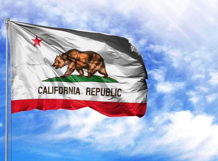 California state flag waving against a blue sky