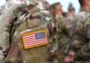 Blackbeard Hits Carriers—At Last U.S. flag patch on a camouflage military uniform