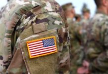 Blackbeard Hits Carriers—At Last U.S. flag patch on a camouflage military uniform