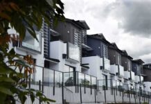 City Appointee’s Posts Torch Homeownership Modern townhouse row with glass balconies and metal accents under cloudy sky