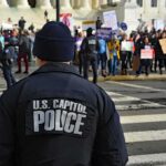 What’s McConnell Hiding? Police Get Involved Police officer monitoring a protest on a city street