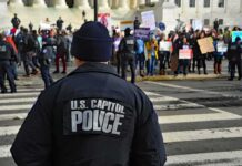 Police officer monitoring a protest on a city street