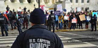 Police officer monitoring a protest on a city street