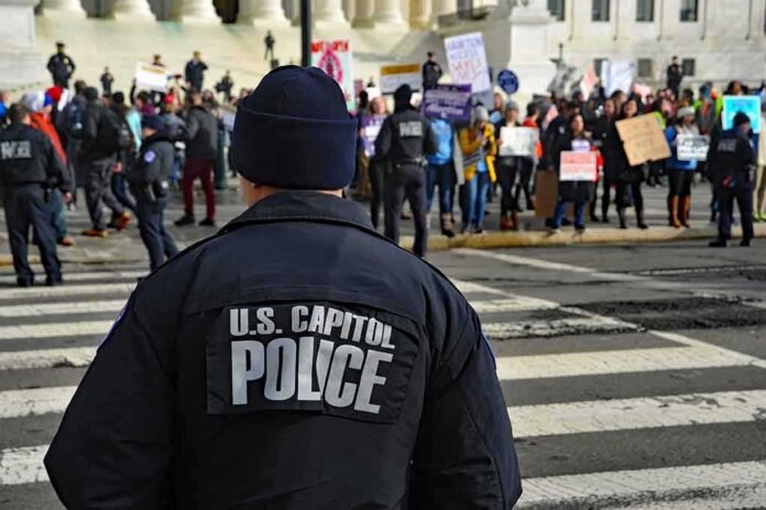 shutterstock_1297580413 Police officer monitoring a protest on a city street
