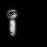 Child Exploitation Ring Tied To Ocean Liners face peering through a keyhole in darkness