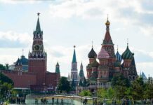 Saint Basil's Cathedral and Kremlin towers under a cloudy sky