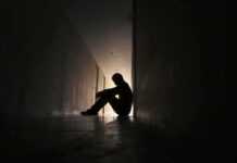 Ben Affleck’s Addiction Take Triggers Firestorm Silhouette of a person sitting on the floor in a dim hallway