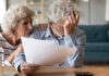 Work Till When? Shapiro Lights Fuse Older couple reviewing bills at home