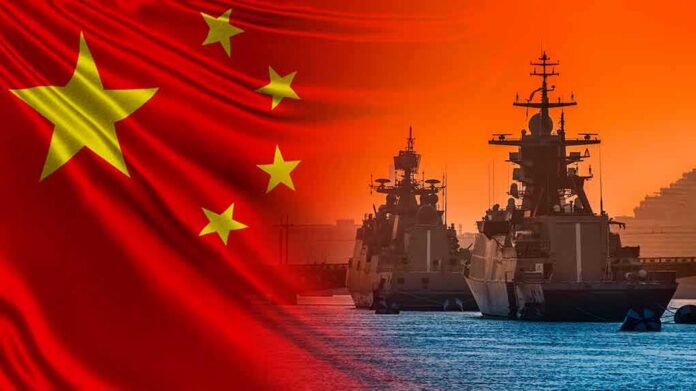 shutterstock_1679306527 Chinese flag overlaid on warships at harbor during sunset